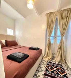 a bedroom with a large bed and a window at City Center, Special Cosy Home in Tangier