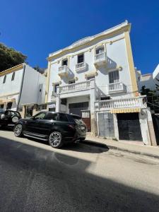 a black car parked in front of a white building at City Center, Special Cosy Home in Tangier