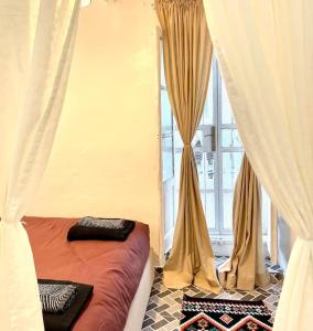 a bed in a room with curtains and a window at City Center, Special Cosy Home in Tangier