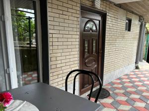 a table and chair in front of a door at Guest House HAPPY HOUSE in Kutaisi +6 photos