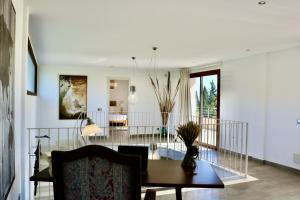 a living room with a table and a dining room at Can Mutxo in Biniamar