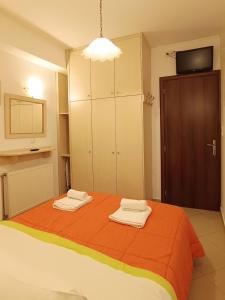 a bedroom with a bed with two towels on it at To Agioklima in Ioannina