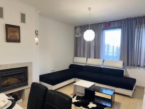 a living room with a couch and a fireplace at Grand Monastery Pamporovo Luxury Apartment in Pamporovo