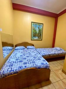 two beds in a room with two beds sidx sidx sidx at HOSPEDAJE Y TURISMO SOL & LUNA E.I.R.L in Tarapoto