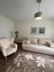 a living room with a couch and a chair at Une-max in Nida