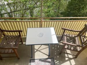 a white table and two chairs on a balcony at Ferienwohnung Traumschleife Klettersteig in Boppard