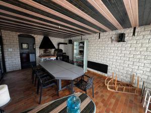 a dining room with a table and chairs and a brick wall at Mon Rêve in Hazelbourg +4 photos