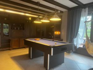 a pool table in a living room with lights at Mon Rêve in Hazelbourg