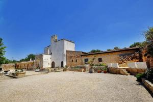 a large building with a large yard in front of it at Masseria Bianca in Taurisano