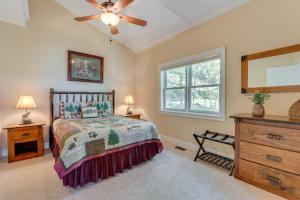 a bedroom with a bed and a ceiling fan at Lake-View Condo with Covered Deck in Hiawassee! in Hiawassee