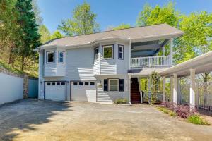 a large white house with a garage at Lake-View Condo with Covered Deck in Hiawassee! in Hiawassee