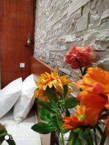 a bouquet of flowers in a vase on a bed at Chrysanty's tea house in Kalabaka