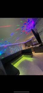 a room with a swimming pool with green and purple lights at 19 Rodney Street Apartments in Liverpool