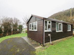a small house in a grassy field with at Chalet 32 in Aberystwyth