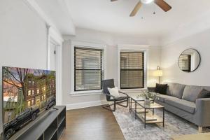 a living room with a couch and a tv at 3BR Vibrant Apartment in Hyde Park - Bstone 5310-1 in Chicago