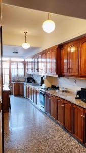 a large kitchen with wooden cabinets and an island at Hotel Boutique Casa & Cava in Mendoza