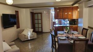 a dining room with a table with chairs and a kitchen at Hotel Boutique Casa & Cava in Mendoza