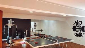 a gym with a ping pong table in a room at Hotel Boutique Casa & Cava in Mendoza