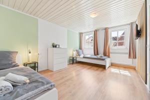 a bedroom with a bed and a window at home2stay Apartments Wendlingen Kitchen,Wifi,Smart TV NEW in Wendlingen am Neckar