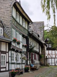 an old building with flower boxes on the windows at Brockenblick in Goslar