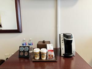a table with a coffee maker and a coffeemaker at Divya Sutra Plaza and Conference Centre Calgary Airport in Calgary
