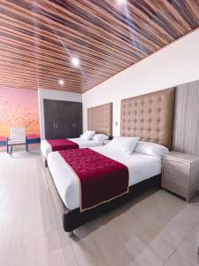 Katil atau katil-katil dalam bilik di Hotel Punta Arena Spa Boutique