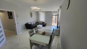 a living room with a table and a couch at EL-EM Apartments-G 402 in Balchik