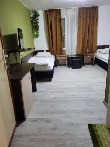 a hotel room with two beds and a desk at Solar in Plovdiv +3 photos