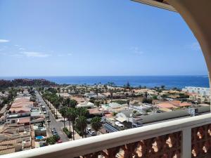 a view of a city from a balcony at Margherita House Tenerife, Wonderful Ocean View in Palm-mar