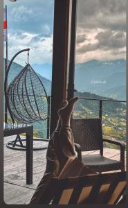 a person sitting on a bench looking out a window at a view at The overlook cottage in Batumi