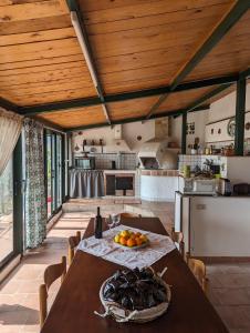 a kitchen with a table with a bowl of fruit on it at Villa Artemis in Graniti