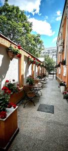a patio with tables and flowers on a building at BUCUR 9 in Bucharest