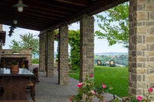 an outdoor patio with a table and a fireplace at B&B La Casa del Gallese in Sorbolongo