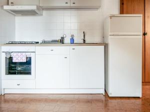 a kitchen with white cabinets and a refrigerator at Al Duomo in Enna