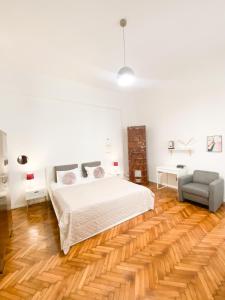 a white bedroom with a bed and a couch at Perfect Stay in Cluj-Napoca