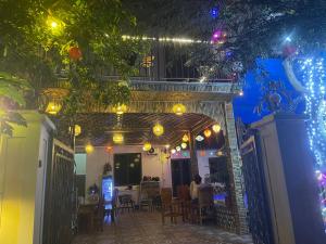 a patio with a table and chairs and lights at Tam Cốc Yến Nhi Homestay in Ninh Binh