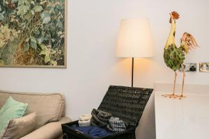 a living room with a lamp and a chair at Beautiful 1 Bedroom in The Heart of Bethnal Green in London