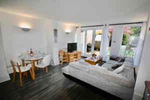 a living room with a couch and a table at Bournemouth Hot Tub & Sauna Holiday Let in Bournemouth