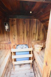 a inside of a wooden cabin with a bed in it at Bournemouth Hot Tub & Sauna Holiday Let in Bournemouth