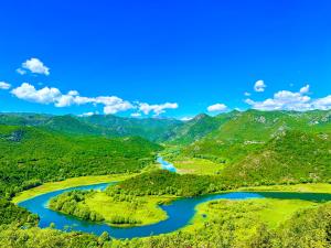 a river in a valley with green mountains at S&M Apartments in Rijeka Crnojevića