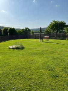 a park with a bench in the middle of a field at A cosy basement apartment in Hluboká nad Vltavou