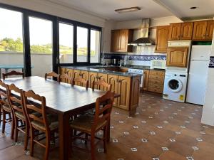 a kitchen with a table and chairs in a kitchen at ONDAETXE in Villabuena de Álava