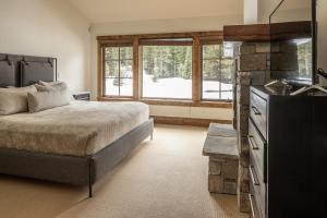 ビッグスカイにあるSpanish Peaks | Homestead Cabin 59のベッドルーム1室(ベッド1台、大きな窓付)