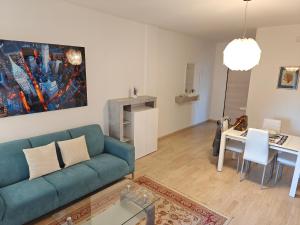 a living room with a blue couch and a table at Appartamento donatello in Imola
