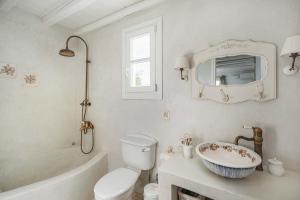 a bathroom with a sink and a toilet and a tub at Samanti House, Leivadi Serifos in Livadi +24 photos