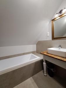 a bathroom with a white tub and a sink at Saneczkowa 1 in Piechowice +51 photos