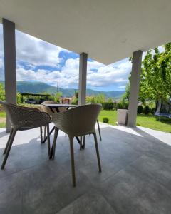 a table and chairs on a patio with a view at Duos East in Soko Banja