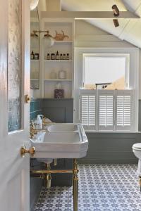 a bathroom with a sink and a window at Cosy retreat, perfectly located just a min walk from Deal Beach and Castle in Deal