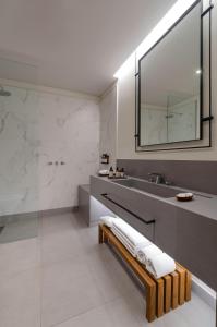 a bathroom with a sink and a mirror at El Bodeguero Hotel in Salta