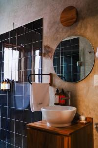 a bathroom with a sink and a mirror at Hotel Boutique Casa de Arte Oaxaca, Art Gallery & Pool in Oaxaca City